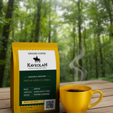 Kaveolah Papua New Guinea coffee package with a yellow mug of steaming coffee on a wooden surface with a forest background